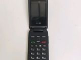 a black cell phone sitting on top of a white table