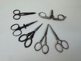 several pairs of scissors are arranged in a circle on a white surface