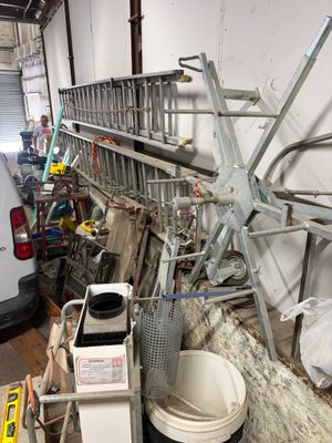 a white van parked in a garage next to a pile of junk