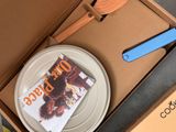 a box with a magazine and a plate with a spoon in it