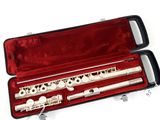 a flute in a case on a white surface