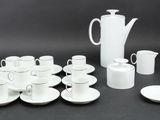 a lot of cups and saucers sitting on a table