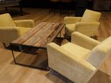 four chairs and a table in the middle of a room