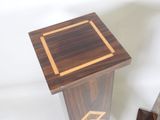 a small wooden table with a square design on top of it