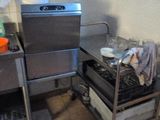 a kitchen with a stove, sink, and oven in it
