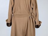 an image of a brown coat with a fur collar on a mannequin stand
