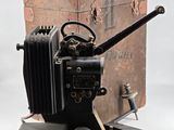 an old camera sitting on top of a wooden box