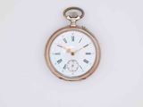 a gold pocket watch with roman numerals on the face