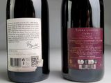 two bottles of wine sitting next to each other on a table