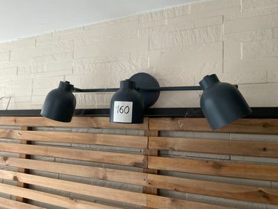 three lights on the wall above the bed