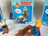 three action figures that are on display in front of a box