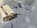 a blue shirt wrapped in plastic on a table
