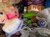 a doll that is sitting on a table with other toys