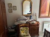 une chambre avec un lit et un bureau sur lequel est posé un miroir