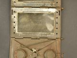 a small metal box with a mirror on it
