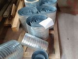 a pile of metal pipes sitting on a pallet in a warehouse