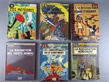 six books on a table, one of which is in french and the other of which are in french