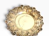 a silver plate on a white surface with a white background