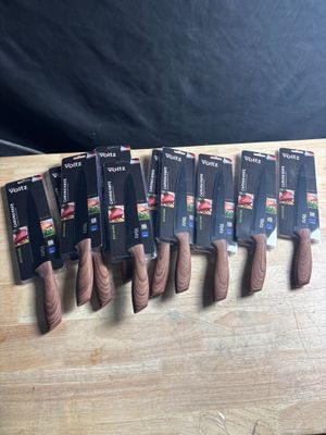 several knives are lined up on a cutting board on a table