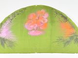 a green fan with pink flowers and pine trees on it