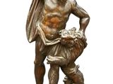 statue en bronze représentant un homme avec un chien, posée sur un socle