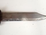 a large knife that is laying on a table