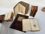 several old books are sitting on a table next to a cup of coffee