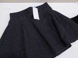 a close up of a skirt on a table with a tag on it