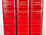 four red books sitting on top of each other on a table