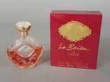 an image of a bottle of perfume sitting next to a red box