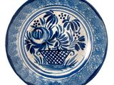 a blue and white plate with flowers on it