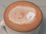 a cup with a tag on it sitting on a table