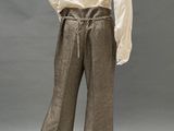 an image of a mannequin wearing a white shirt and brown pants