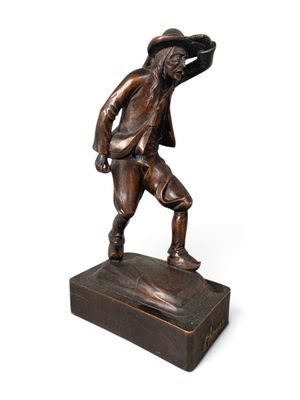 bronze statue of a man with a hat on his head