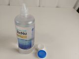 a bottle of hand sanitizer next to a bottle of toothpaste