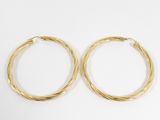 a pair of gold hoop earrings on a white background