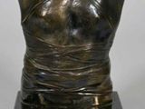 bronze bust of a woman on a black marble base
