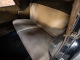 a seat in the back of a car that is dirty