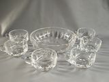 a lot of glasses and a bowl on a table