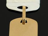 gold plated dog tag on a black background with a price tag attached to it