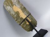 a large rock with a metal stand on a white surface