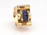 an image of a gold ring with a blue stone inside of it