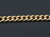 a close up of a gold bracelet on a black background