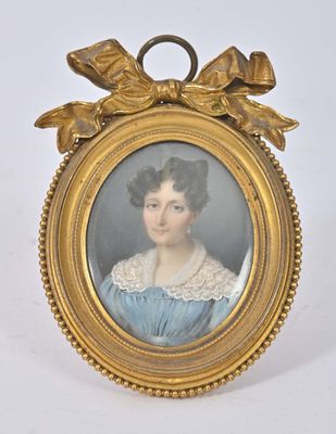 an old picture of a woman in a blue dress with a bow around her neck