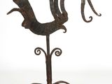 wrought iron rooster on a stand on a white background