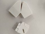 two pieces of white plastic that are on a table