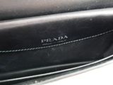 the inside of a prada purse with a black leather lining