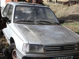 a silver car that is parked in the dirt