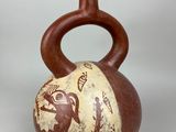 a brown and white vase with a bird design on it