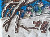 a tile with a picture of a group of birds in the snow